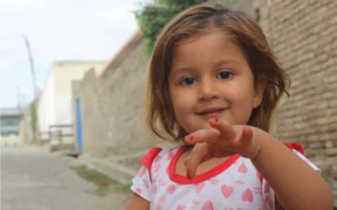 A child shows off her newly painted finger nails