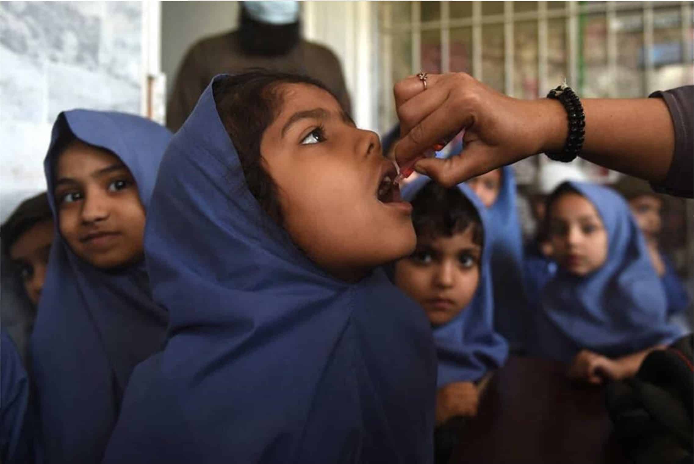 Children in Karachi, Pakistan wait their turn for polio vaccine