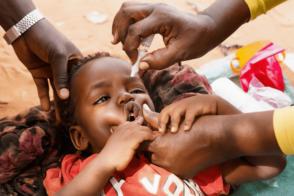 A child in Sudan is vaccinated against Polio